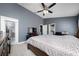 Bedroom showcasing neutral paint, large bed, and connecting door to bathroom at 5100 Violet Ln, Kissimmee, FL 34758