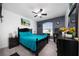 Spacious bedroom with gray accent wall features a ceiling fan and a large window at 5100 Violet Ln, Kissimmee, FL 34758