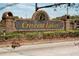 Elegant brick entrance sign for Crescent Lakes, surrounded by lush landscaping at 5100 Violet Ln, Kissimmee, FL 34758
