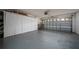 Spacious garage with storage, a garage door with windows, and grey flooring at 5100 Violet Ln, Kissimmee, FL 34758