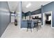 Open-concept living area with bar seating, tile floors, and recessed lighting at 5100 Violet Ln, Kissimmee, FL 34758