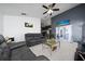 Comfortable living room with dark leather furniture, ceiling fan, and view of the outdoors at 5100 Violet Ln, Kissimmee, FL 34758