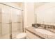 Bright bathroom features a walk-in shower with glass doors and granite counters at 5231 Wildwood Way, Davenport, FL 33837
