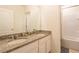 Bathroom features dual sinks with granite countertops and shower with patterned curtain at 5231 Wildwood Way, Davenport, FL 33837