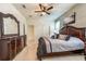 Inviting bedroom features a large wooden dresser, ceiling fan, and a comfortable bed at 5231 Wildwood Way, Davenport, FL 33837
