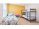 Bedroom featuring a bunk bed, twin bed, colorful wall, and natural lighting at 5231 Wildwood Way, Davenport, FL 33837