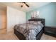 Comfortable bedroom featuring plush carpet, a ceiling fan, and a stylish paisley patterned comforter set at 5231 Wildwood Way, Davenport, FL 33837