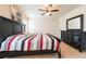 Bedroom with a black bed frame, neutral colored walls, and carpeted floors at 5231 Wildwood Way, Davenport, FL 33837