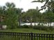 Beautifully landscaped grounds offer a glimpse of the community pool area beyond the fence at 5231 Wildwood Way, Davenport, FL 33837