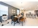Cozy dining area with a wooden table, bench seating, and a high chair nearby at 5231 Wildwood Way, Davenport, FL 33837