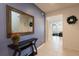 Inviting foyer with a large decorative mirror, a sleek console table, and tile flooring at 5231 Wildwood Way, Davenport, FL 33837