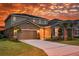 Charming two-story home boasts a well-manicured lawn and a driveway to the garage at 5231 Wildwood Way, Davenport, FL 33837