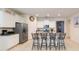 Open kitchen with granite counters, a stainless steel refrigerator, and an island with seating at 5231 Wildwood Way, Davenport, FL 33837