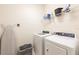 Functional laundry room equipped with a washer, dryer, and convenient shelving for storage at 5231 Wildwood Way, Davenport, FL 33837