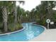 Community lazy river surrounded by lush landscaping, perfect for relaxation at 5231 Wildwood Way, Davenport, FL 33837