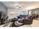 Combined living and dining area with modern furniture, large windows, and stylish decor at 5231 Wildwood Way, Davenport, FL 33837