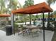 Relax in the covered outdoor lounge area with seating and shade from the sun at 5231 Wildwood Way, Davenport, FL 33837