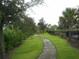 Serene winding path surrounded by lush greenery, offering a peaceful and scenic walking experience at 5231 Wildwood Way, Davenport, FL 33837