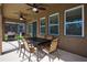 Covered patio featuring a dining table and ceiling fans, perfect for outdoor dining at 5231 Wildwood Way, Davenport, FL 33837