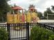 Bright and colorful playground with slides, climbing structures, and swings, perfect for outdoor fun and recreation at 5231 Wildwood Way, Davenport, FL 33837