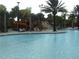 Community pool with water slide and well-manicured landscaping at 5231 Wildwood Way, Davenport, FL 33837