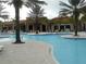 Stunning community pool with well-manicured landscaping and palm trees at 5231 Wildwood Way, Davenport, FL 33837