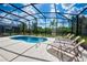 Backyard pool area with covered patio and lounge chairs at 5231 Wildwood Way, Davenport, FL 33837