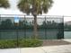 Well-maintained tennis courts surrounded by lush landscaping, offering a prime recreational amenity for residents at 5231 Wildwood Way, Davenport, FL 33837