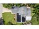 Aerial view of the home with solar panels, green lawn, and mature trees at 878 Elgin Dr, Winter Springs, FL 32708