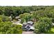 Aerial view of a gray home featuring a modern roof with solar panels in a lush green community at 878 Elgin Dr, Winter Springs, FL 32708