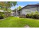 Exterior view of the home's backyard with built-in grill and screened in patio at 878 Elgin Dr, Winter Springs, FL 32708