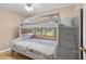 Bedroom boasting a bunk bed with built-in stairs and storage, bathed in natural light at 878 Elgin Dr, Winter Springs, FL 32708