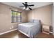 Cozy bedroom showcasing a bed with a gray comforter and a side table next to a window at 878 Elgin Dr, Winter Springs, FL 32708