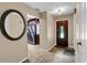 Inviting foyer featuring a decorative mirror, tiled flooring, and a glimpse into the kitchen at 878 Elgin Dr, Winter Springs, FL 32708