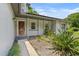 Welcoming front entry featuring a decorative wood door and vibrant landscaping for added charm at 878 Elgin Dr, Winter Springs, FL 32708