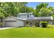 Charming home featuring solar panels, a well-maintained lawn, and lush landscaping, enhancing curb appeal at 878 Elgin Dr, Winter Springs, FL 32708