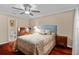 Comfortable bedroom features stylish decor, rich wood flooring, and a ceiling fan at 878 Elgin Dr, Winter Springs, FL 32708
