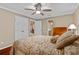Spacious bedroom features a closet, ceiling fan, and neutral walls and trim at 878 Elgin Dr, Winter Springs, FL 32708