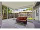 Screened patio with an outdoor sofa, rug, and view of the fenced backyard at 878 Elgin Dr, Winter Springs, FL 32708