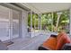 Screened patio with a cozy cushioned outdoor sofa and view of backyard grill at 878 Elgin Dr, Winter Springs, FL 32708