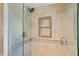 Modern shower featuring decorative tile, glass door and convenient inset shelving at 878 Elgin Dr, Winter Springs, FL 32708