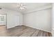Spacious bedroom with hardwood floors, a ceiling fan, and closet space at 911 N Orange Ave # 321, Orlando, FL 32801