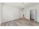 Bright bedroom features wood-look floors, ceiling fan, closet, and ensuite bathroom access at 911 N Orange Ave # 321, Orlando, FL 32801