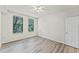 Bedroom features wood-look floors, two windows with blinds, and neutral wall color at 911 N Orange Ave # 321, Orlando, FL 32801