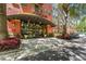 Stylish condo building entrance with glass doors, lush landscaping, and clear signage for Uptown Place at 911 N Orange Ave # 321, Orlando, FL 32801