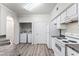 Bright kitchen with white cabinets, laminate countertops, new appliances, and a washer/dryer closet at 911 N Orange Ave # 321, Orlando, FL 32801