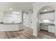 Open kitchenette with updated countertops, white cabinets, and modern lighting at 911 N Orange Ave # 321, Orlando, FL 32801