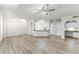 Open-concept living area with wood flooring, a kitchen bar, and easy access to bedrooms and the entry door at 911 N Orange Ave # 321, Orlando, FL 32801