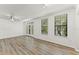 A large living room with wood floors, balcony access, and natural light from multiple windows at 911 N Orange Ave # 321, Orlando, FL 32801