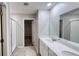 Bright bathroom featuring a double sink vanity with modern fixtures and a glass-enclosed shower at 1343 Lassen St, Haines City, FL 33844